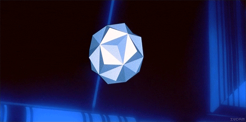 Bit, shifting between a faceted gray spheroid, a yellow octahedron, and a spiky red starlike shape