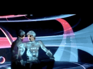 Clip of the cut scene from TRON. Yori and Tron are seated together. Tron says: Are you sure we'll be safe here? Yori touches the circuits on his chest and replies: For a while.