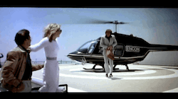 Flynn lands the Encom helicopter on the roof where he meets Lora and Alan, and greets them with a group hug, saying: Greetings, programs.
