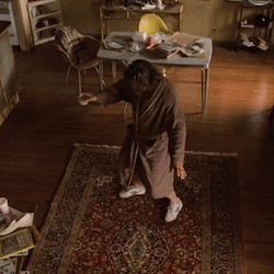 gif of Jeff Bridges' character from The Big Lebowski, "The Dude." he has long flowing hair and is gracefully practicing tai chi while wearing a long robe and standing on his beloved "rug that tied the room together." he looks happy.