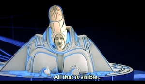 screenshot of Dumont, the Tower Guardian, in his extremely phallic hat and ceremonial outfit that resembles either balls or boobs. Subtitle shows that he is speaking ritual words: All that is visible...