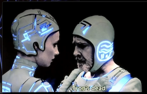 Dumont in his slightly more normal outfit, with Yori. He still has a full beard and mustache. He looks sad because he is reacting to Yori saying "Tron's dead." Which turned out not to be true in that scene, but might be true now.