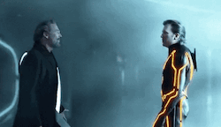 screenshot of the scene at the end of Tron Legacy where Flynn (the Creator of the Grid) confronts Clu (the Perfectionist of the Grid) right before they merge together in an explosion that destroys them both and possibly also the world 