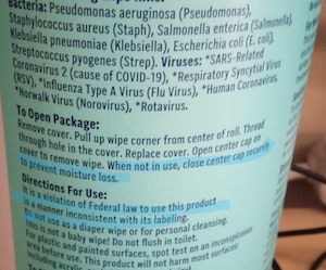 The back of a canister of antibacterial cleaning wipes, listing the instructions for use. Two lines are highlighted. One is: When not in use, close center cap securely to prevent moisture loss. The other is: It is a violation of Federal law to use this product in a manner inconsistent with its labeling.