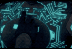 gif from Tron 1982's deleted love scene. Yori touching Tron's circuit patterns, which turn lavender in response. 