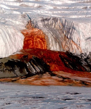 A massive waterfall pouring out of an ice shelf that looks exactly like blood