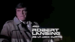 Clip from the intro to the 80's tv show Automan, beginning with a scene of Robert Lansing as Lt Jack Curtis, and then continuing to show a small glowing levitating geometric shape, which hovers over a photo of a woman and alters it to make her appear nude, while the caption reads: "With CURSOR, as himself." CURSOR then draws a glowing heart with arrow around the woman's photo, before flying off toward the cleavage of another woman, who screams and runs. Scene fades out to a parking lot, then the gif re-loops.